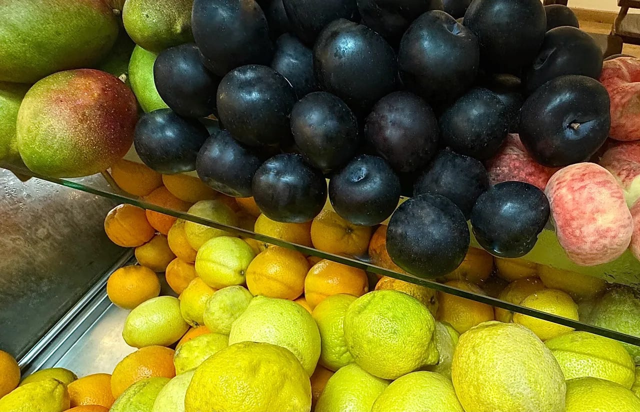 Vitrine de fruta fresca: ameixas, peras e limas